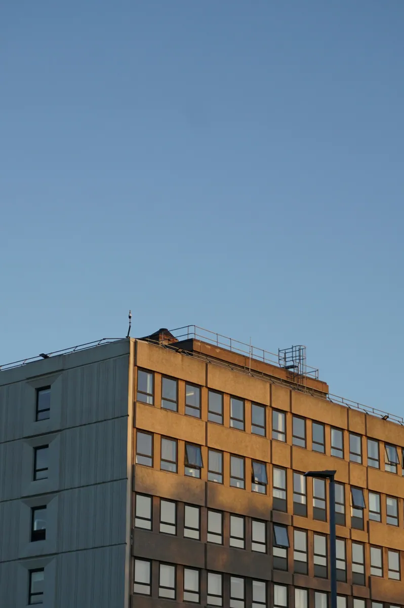 Sunlight falling across the facade of a contemporary office building