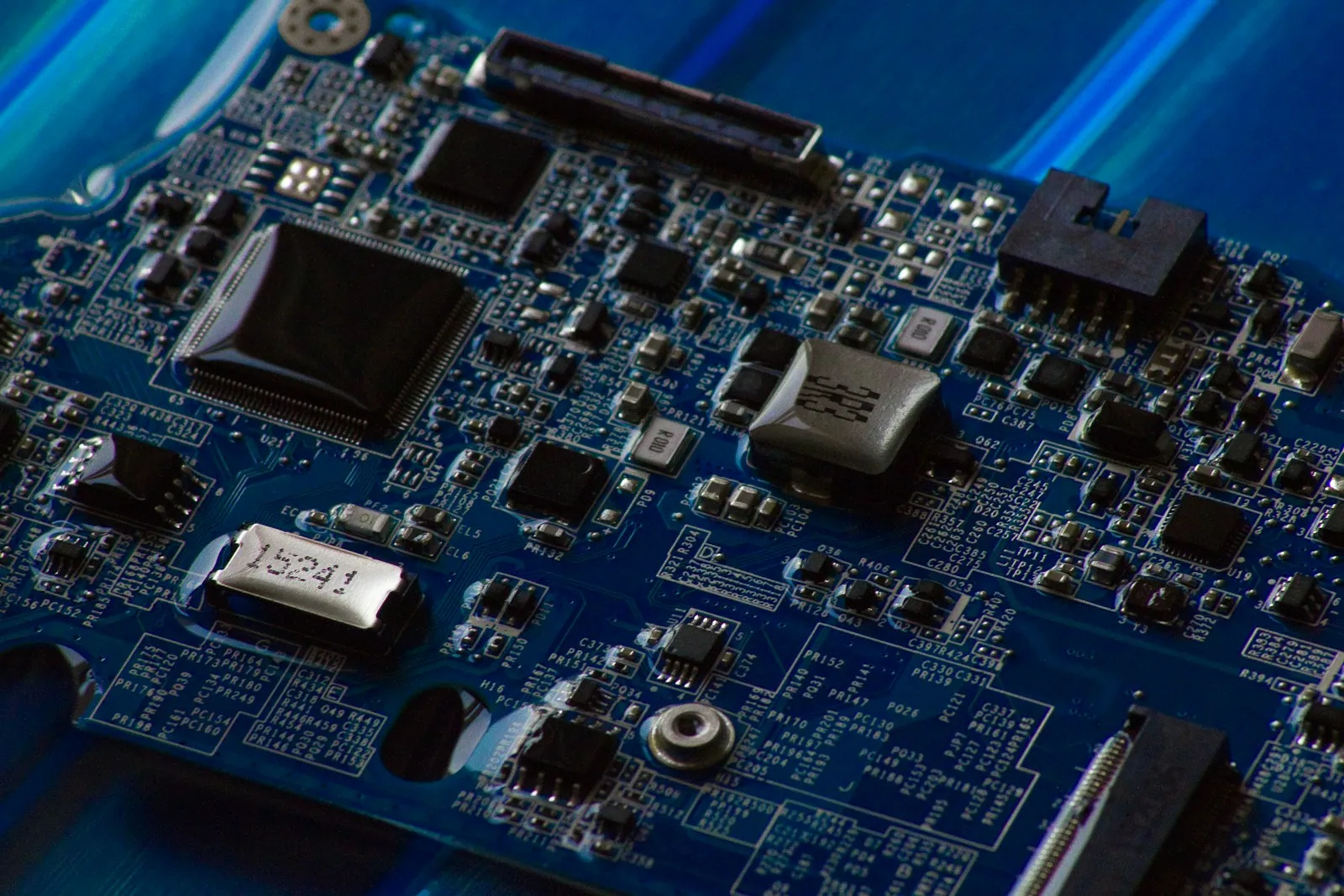 A close view of electronic components on a blue circuit board