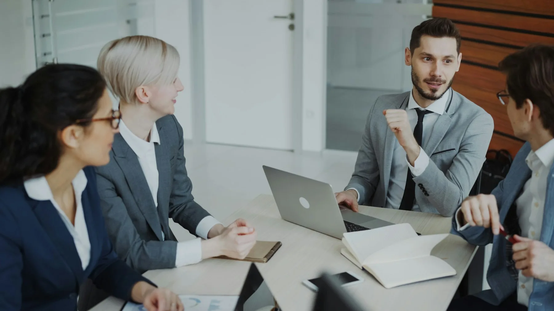 Business professionals discussing an idea around a meeting table